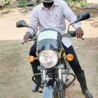 Alex Puhindei uses the motorbike to travel to rural schools